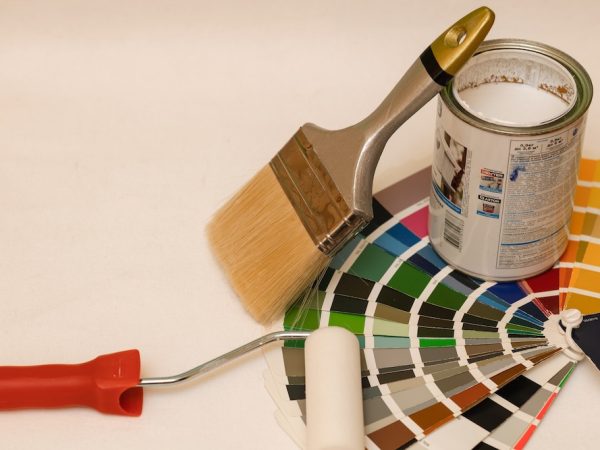 Composition Roller, brush, open can of paint, color palette. Copy space